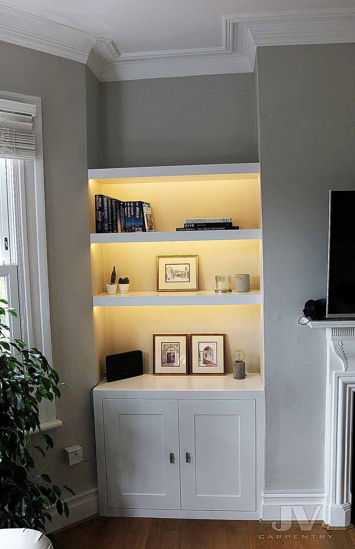alcove shelving with lights and cabinet at the bottom LHS