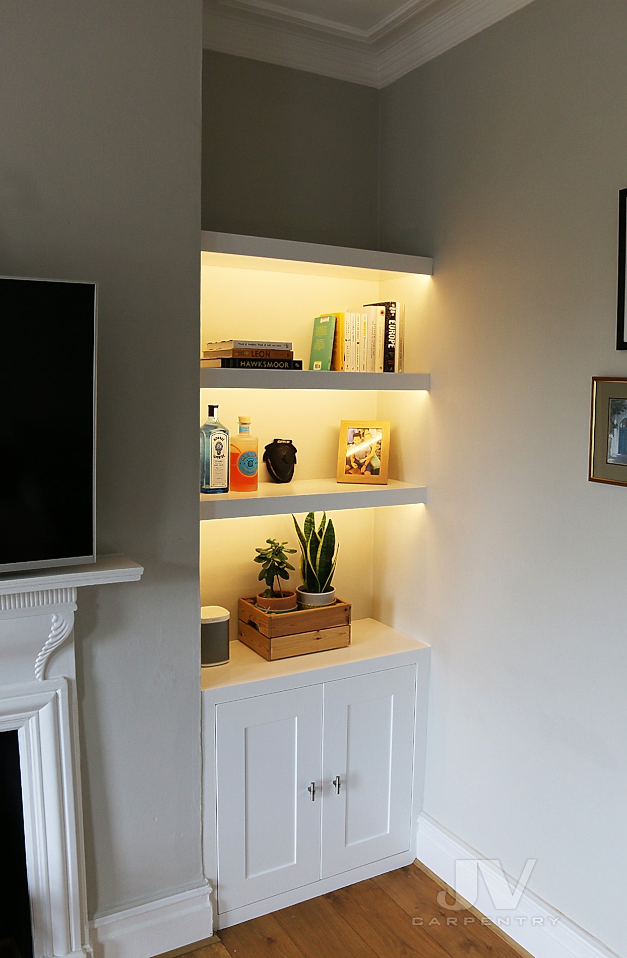 alcove floating shelving with lights and cabinet at the bottom RHS